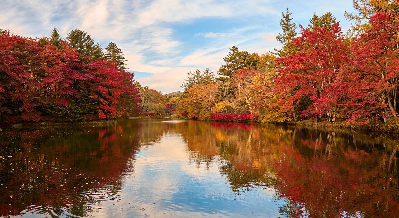 Kumoba Pond surrounded by autumn foliage trees in Karuizawa.